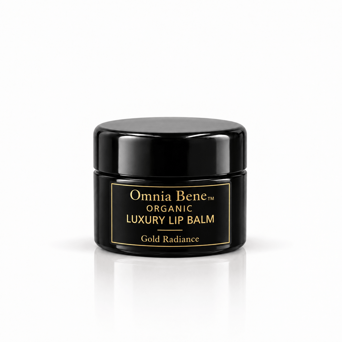 Omnia Bene Organic Luxury Lip Balm in Gold Radiance, a small black jar with gold lettering. A small black jar with gold lettering, organic and vegan. A warm golden sheen over conditioning botanical butters and oils. Wear it alone or over a lip colour.