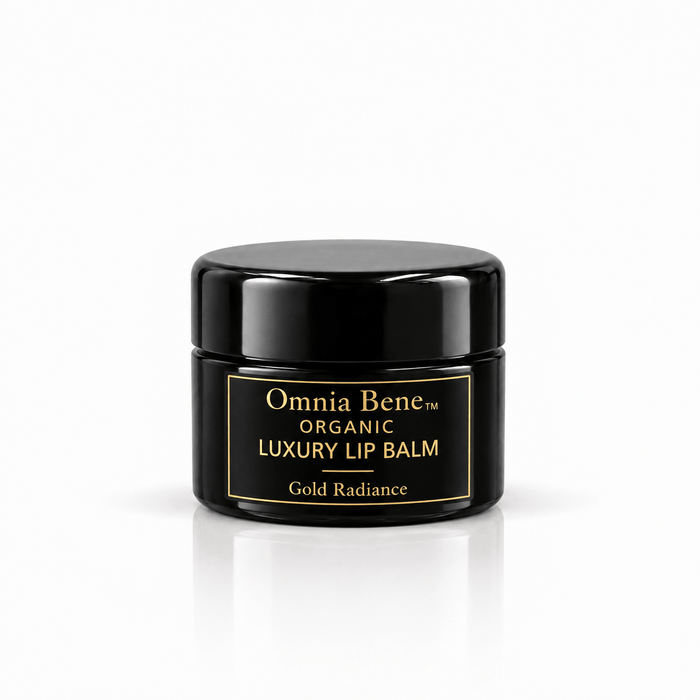 Omnia Bene Organic Luxury Lip Balm in Gold Radiance, a small black jar with gold lettering. A small black jar with gold lettering, organic and vegan. A warm golden sheen over conditioning botanical butters and oils. Wear it alone or over a lip colour.