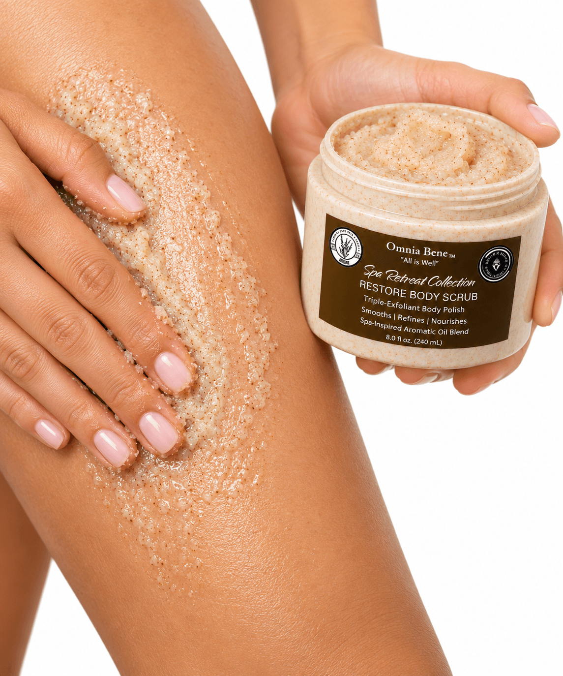 Omnia Bene RESTORE Body Scrub being massaged over a leg, with the open jar held alongside.