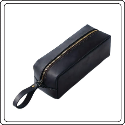 Black toiletry bag with gold zipper on a white background