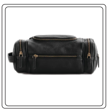 Black leather dopp kit with gold zippers on a white background