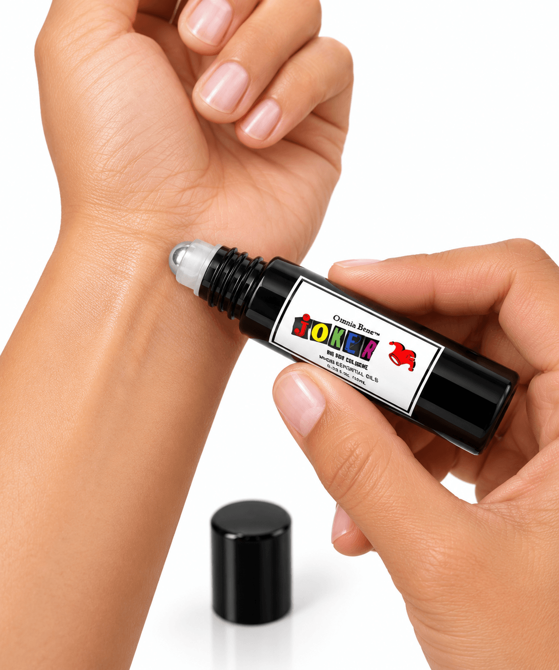 Omnia Bene JOKER boys rollerball cologne being rolled onto the inner wrist.