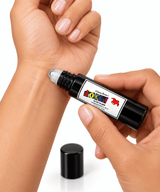 Omnia Bene JOKER boys rollerball cologne being rolled onto the inner wrist.