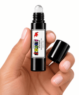 A hand holding an open Omnia Bene JOKER boys rollerball cologne with the cap alongside.