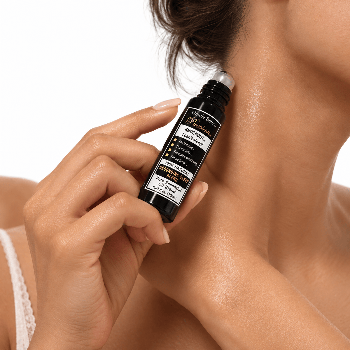 Omnia Bene Puccian KNOCKOUT sleep rollerball being rolled onto the side of the neck.
