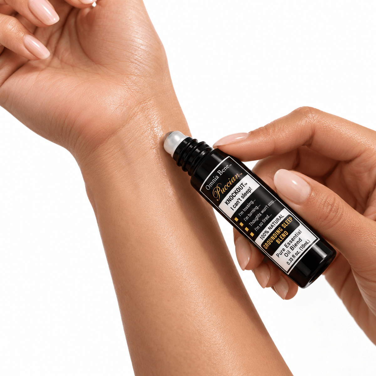 Omnia Bene Puccian KNOCKOUT sleep rollerball being rolled onto the inner wrist.