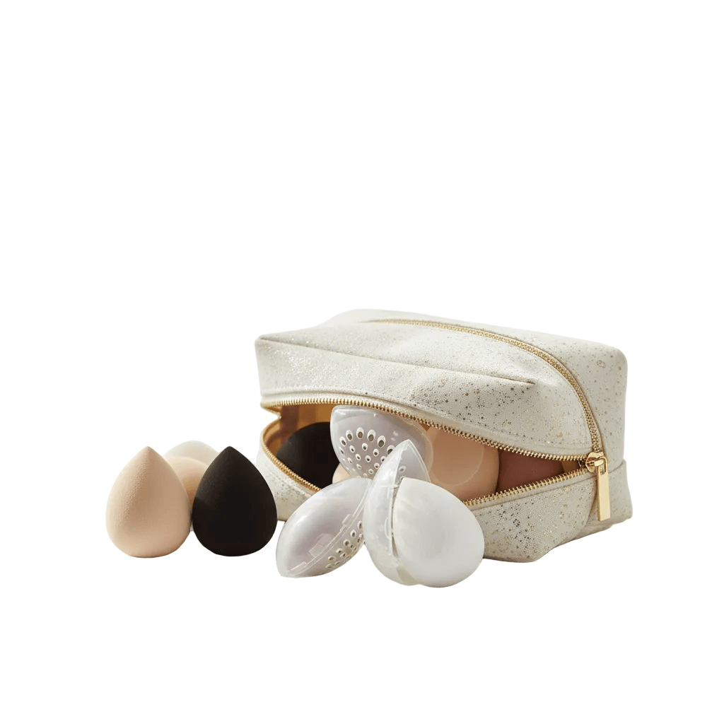 Omnia Bene makeup sponges set with protective cases spilling from a white zip cosmetic pouch.