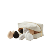 Omnia Bene makeup sponges set with protective cases spilling from a white zip cosmetic pouch.