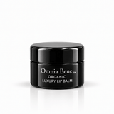 Omnia Bene Organic Luxury Lip Balm in a small black jar with white lettering. A small black jar of organic, vegan lip balm with white lettering. Botanical butters and oils, no petroleum. For dry, chapped lips - over the Vanilla Lip Scrub, or on its own.
