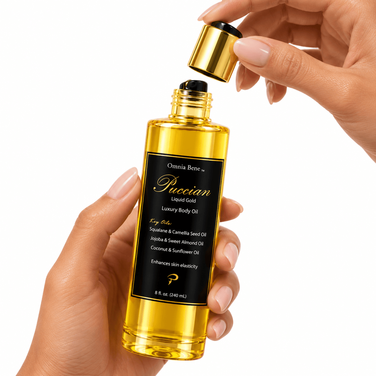 Hands lifting the gold cap from a bottle of Omnia Bene Puccian Liquid Gold luxury body oil.
