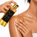 Omnia Bene Puccian Liquid Gold body oil poured onto a shoulder and massaged into the skin.