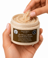 A hand scooping Omnia Bene RESTORE Body Scrub from its Spa Retreat Collection jar.