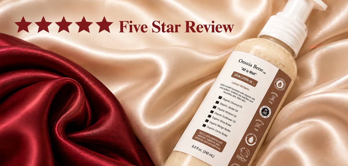 Five Star Review - Omnia Bene Organic Satin Lotion-Oil in Lemon Verbena on red and champagne satin.